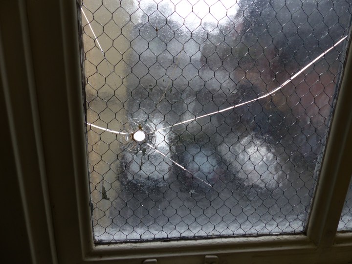 Window gunshot hole